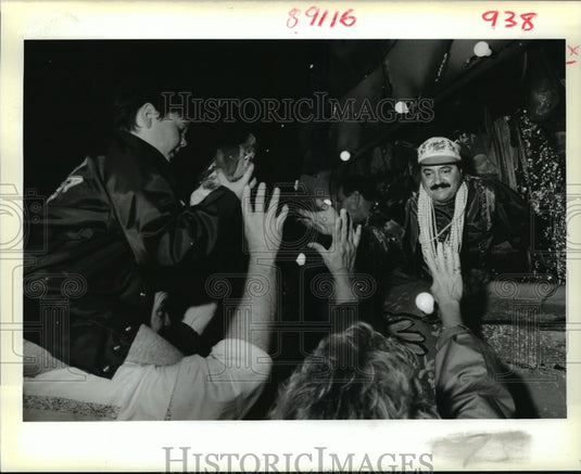 1989 Krewe of Gladiators Mardi Gras parade float rider throws beads - Historic Images