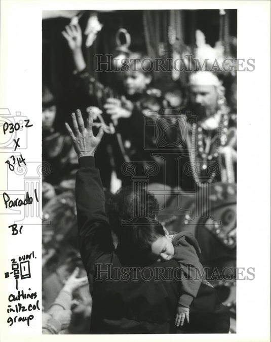 1993 Mike Neal Holds Sleeping Lee Parker at Marc Antony Parade - Historic Images