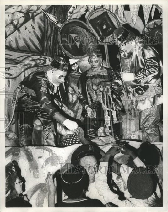 1975 Riders hand out favors in a Proteus parade float on Mardi Gras - Historic Images