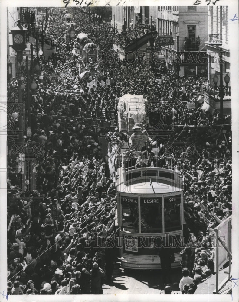 1974 streetcar and floats roll down street for Rex Mardi Gras parade - Historic Images