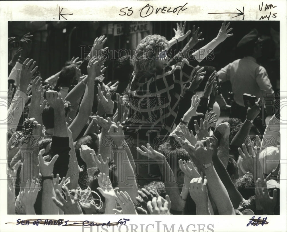 1987 Carnival Spectators with Hands Raised for Throws at Mardi Gras - Historic Images