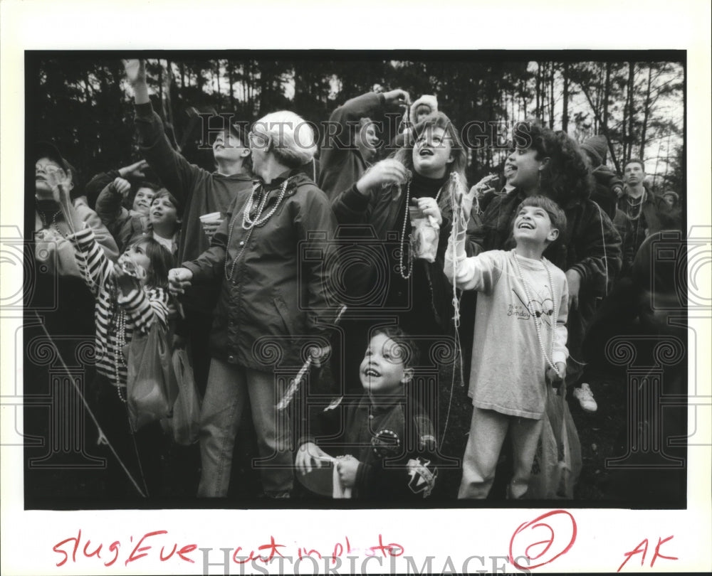 1993 Mardi Gras Spectators Catch Beads at Carnival in New Orleans - Historic Images