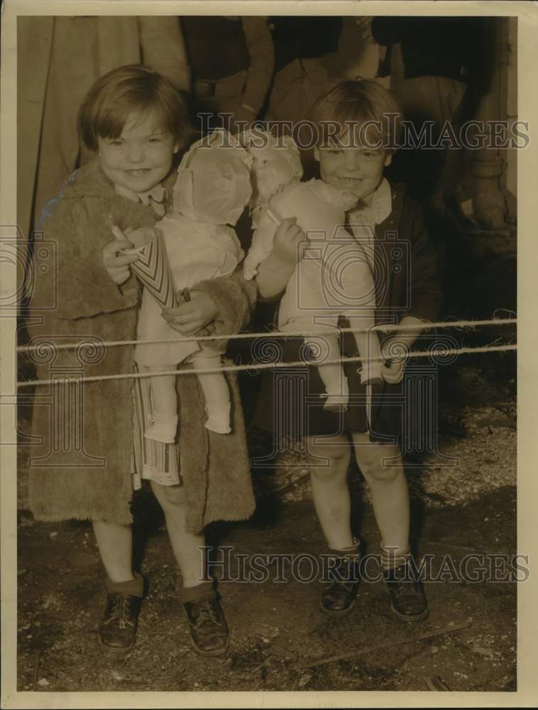 1938 Press Photo Two kids carry their dolls from Doll &amp; Toy Fund - nod00922 - Historic Images