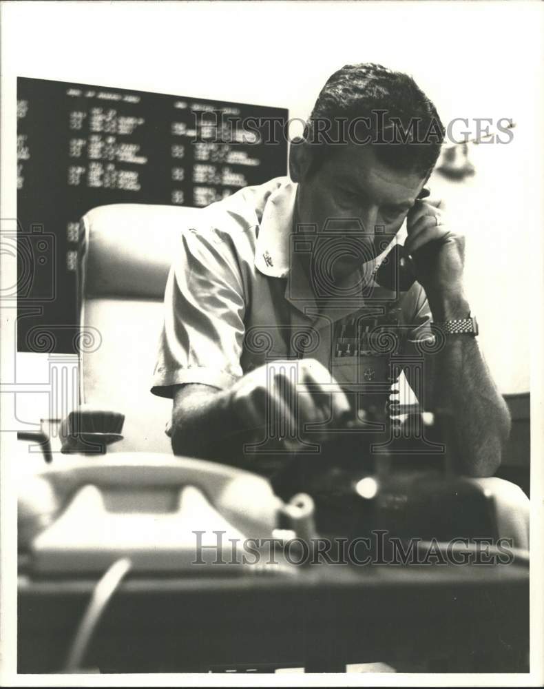 1971 Press Photo Captain Faulk sits at phone desk in his office - Historic Images