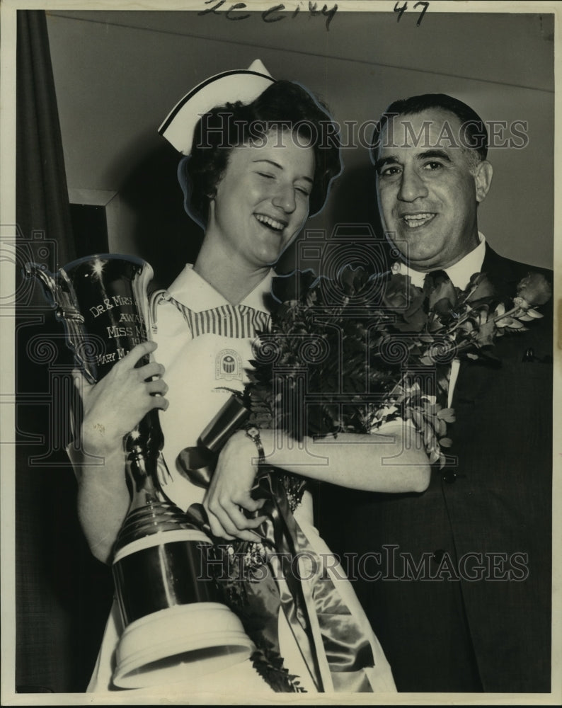 1963 &quot;Miss Mercy&quot; Mary Margaret Coulon as she receives a trophy - Historic Images