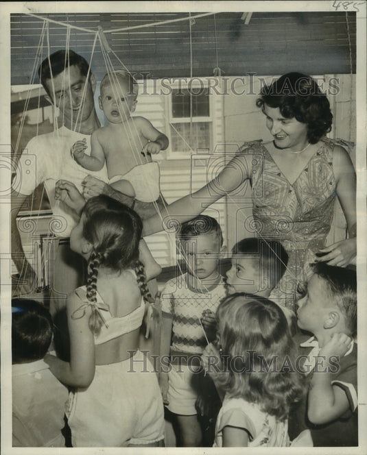 1955 Evelyn and T Costilow get Bunny's birthday party started - Historic Images