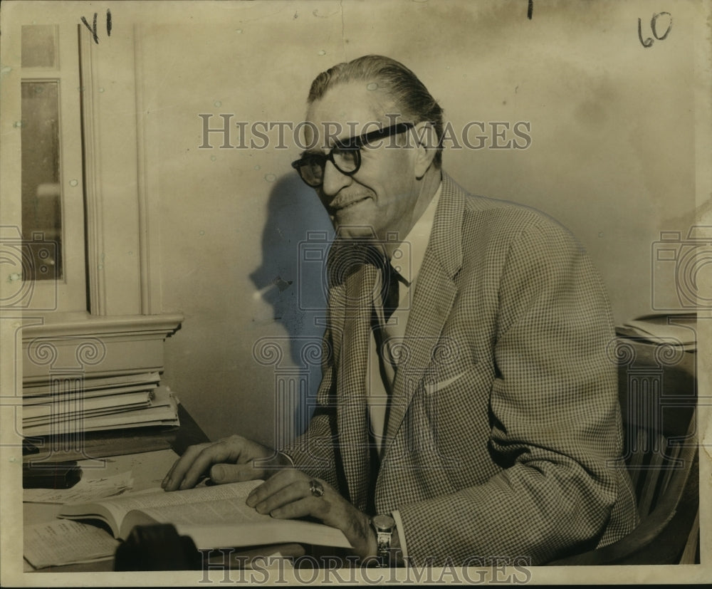 1958 Former police captain Joseph C. Cox looks over seminary lessons - Historic Images