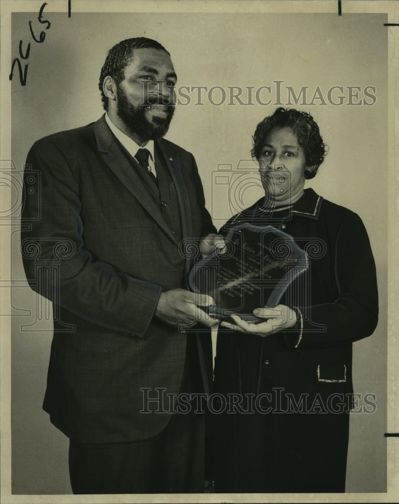 1970 Rev. Lawler Daniels presented with plaque by Mrs. Johnson - Historic Images