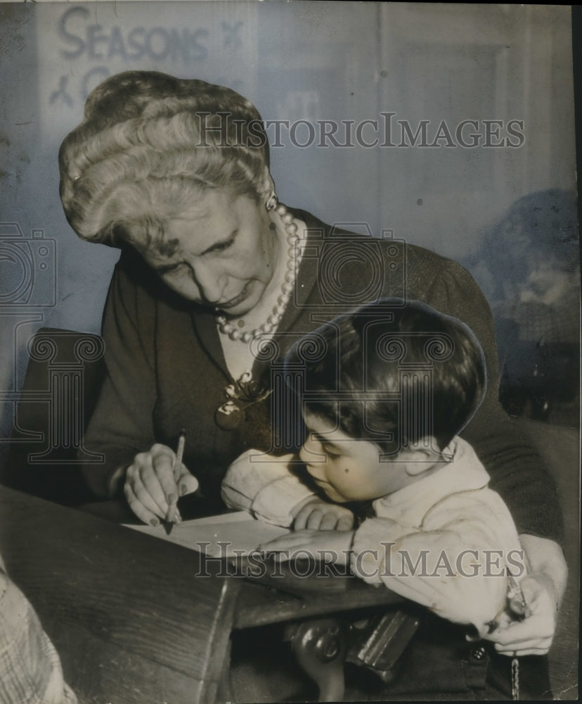 1947 Mrs. Edward Douglas helps David Rosen write a letter to Santa - Historic Images