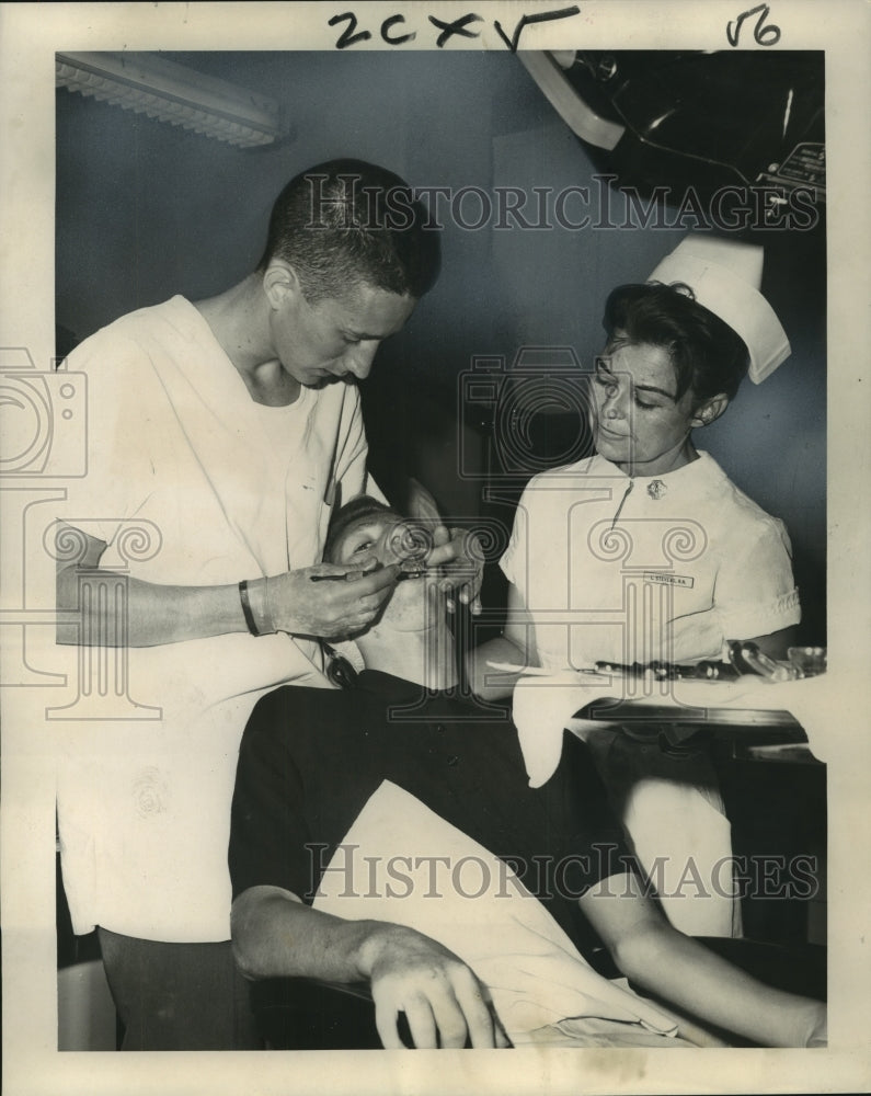 1965 Loyola dental student with a patient at Charity Hospital - Historic Images