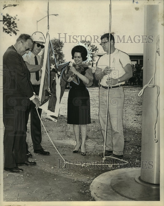 1964 Du Pont's Pontchartrain Works plant employees raise the flag - Historic Images