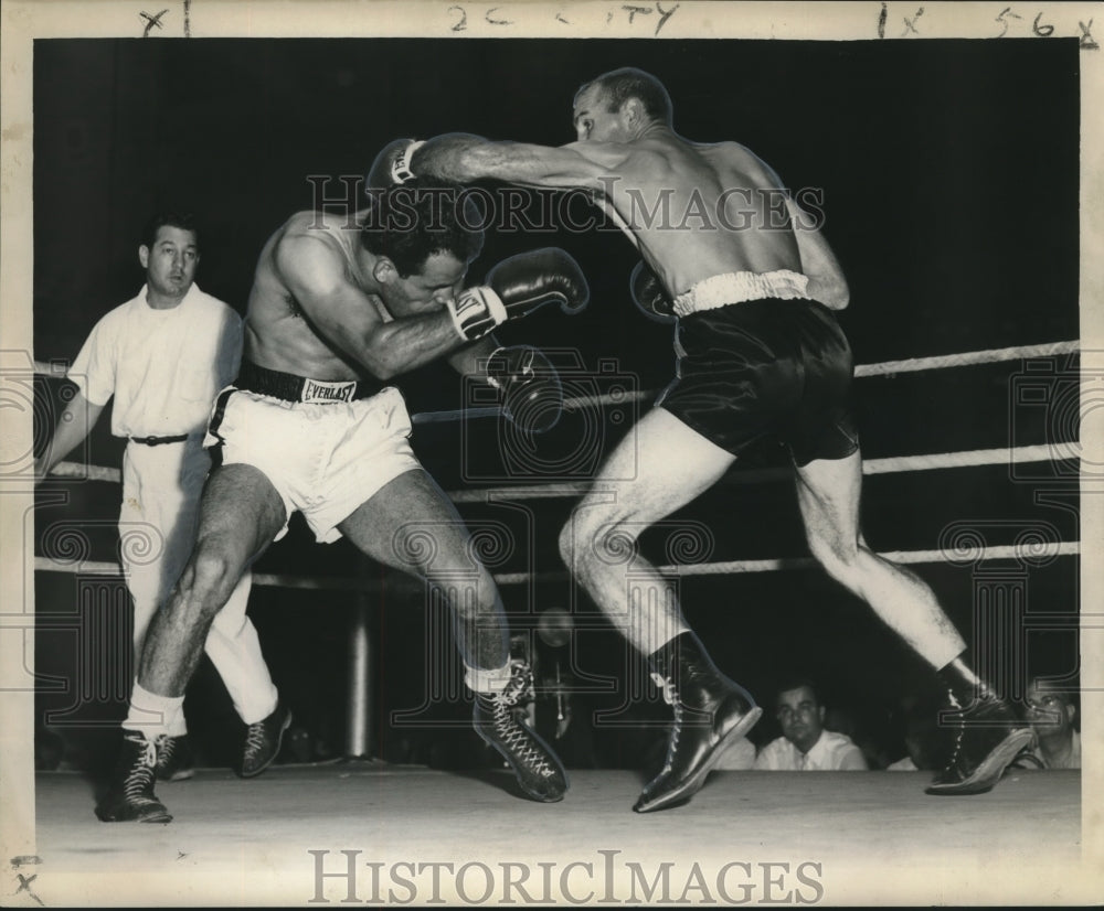 Fighters in boxing ring being watched by referee - Historic Images