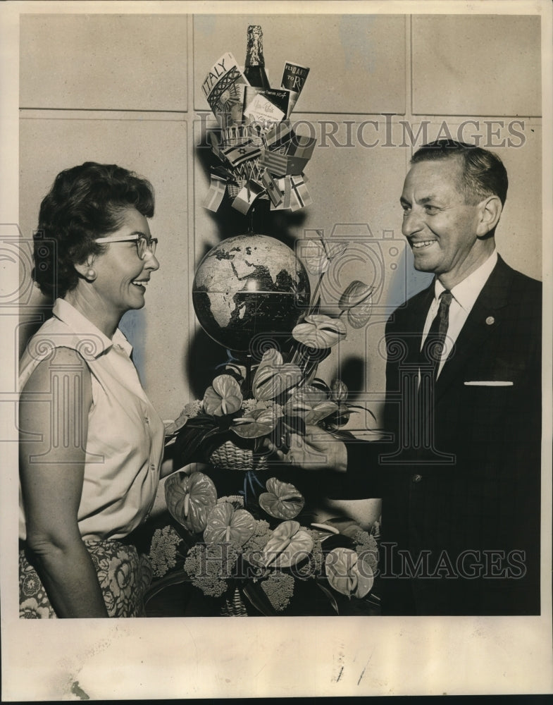 1963 Examining a Bon Voyage floral creation by Mrs. Aliee Zukor - Historic Images