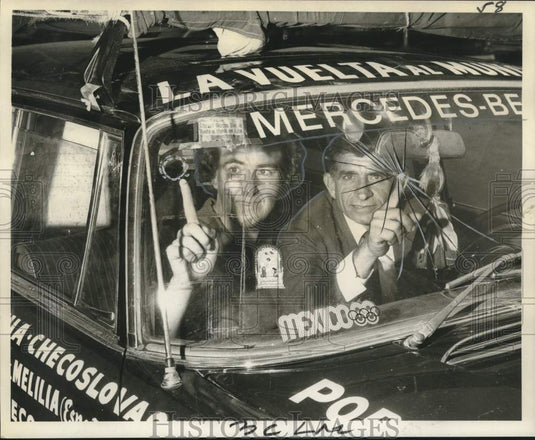 1968 Mr. & Mrs. Anastase Gohumas point to cracked windshield - Historic Images