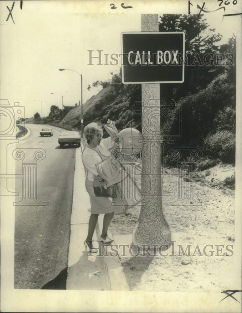 1966 Press Photo Driver demonstrates call box, Capital Beltway Maryland-Historic Images