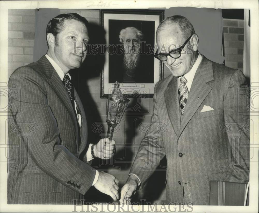 1974 James Jones passes United Fund torch to Wallace B. Schmitz - Historic Images