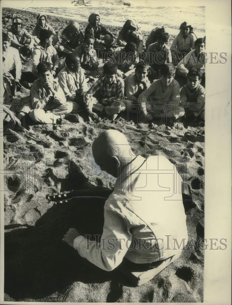 1960 An unidentified man sings for children in Jerusalem - Historic Images