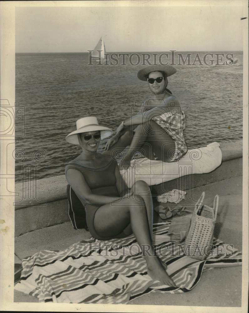 1959 Ladies sunning at Lake Pontchartrain seawall, Louisiana - Historic Images