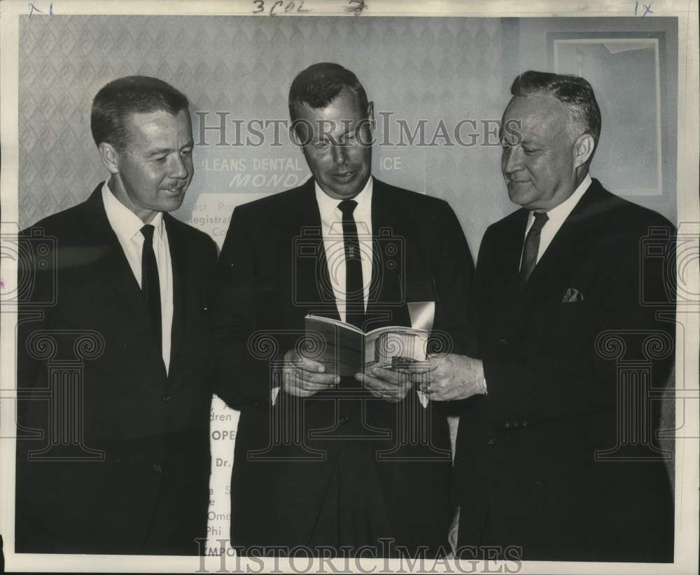 1966 Discussing program of 19th annual New Orleans Dental Conference-Historic Images