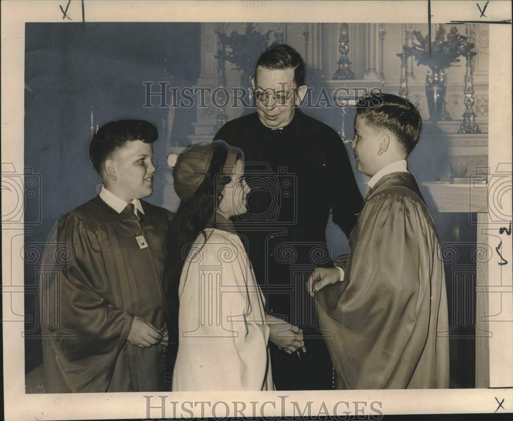 1965 James Cunningham officiates confirmation of Macheca triplets-Historic Images
