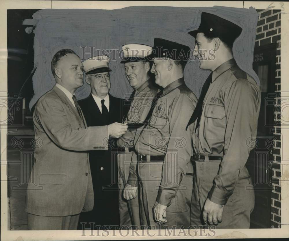 1961 Press Photo Bernard McCloskey checks new fire department uniforms - Historic Images