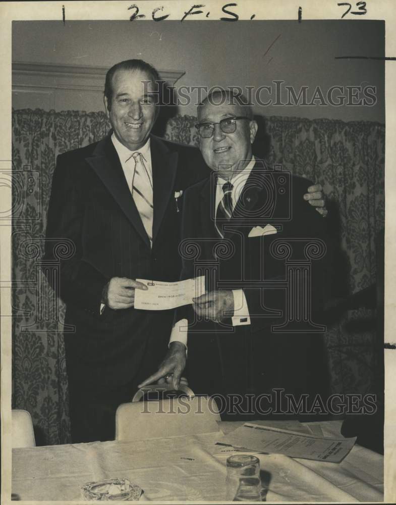 1970 Louis Messina presents check to Charles Zatarain Sr. - Historic Images