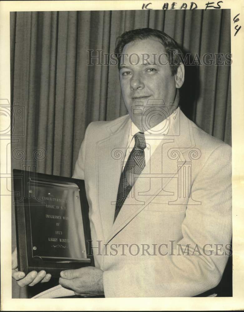 1974 Larry Winter holds &quot;Insurance Man of the Year&quot; award trophy - Historic Images