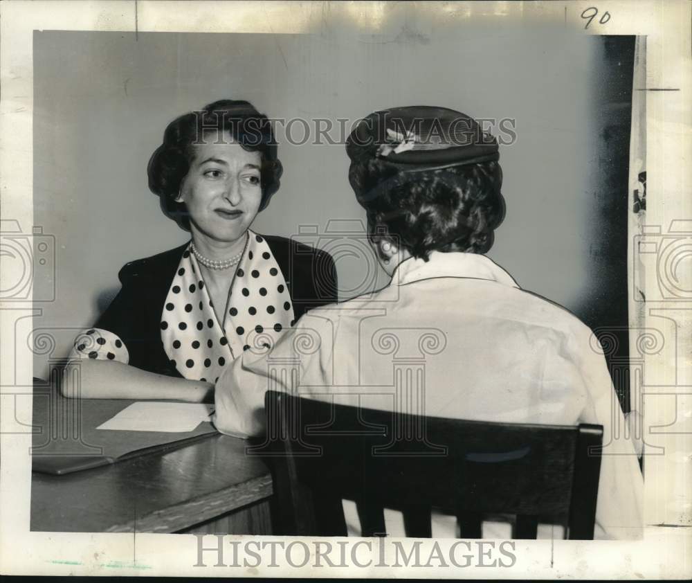 1955 Family Service Society director Viola Weiss talks with client. - Historic Images