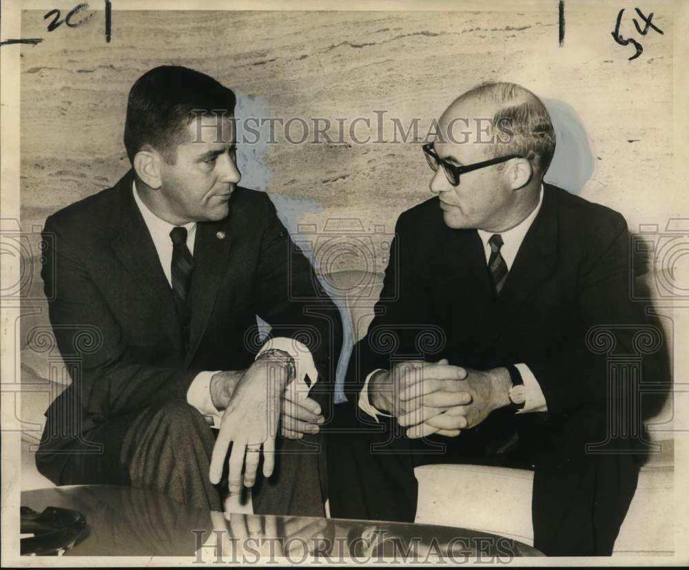 1968 Roy Westran and John Adam chat at underwriters&#39; meeting - Historic Images