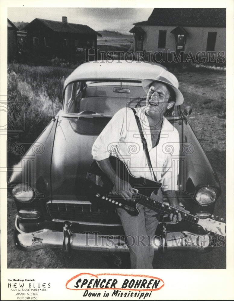 Musician Spencer Bohren Plays His Guitar While Leaning On a Car - Historic Images