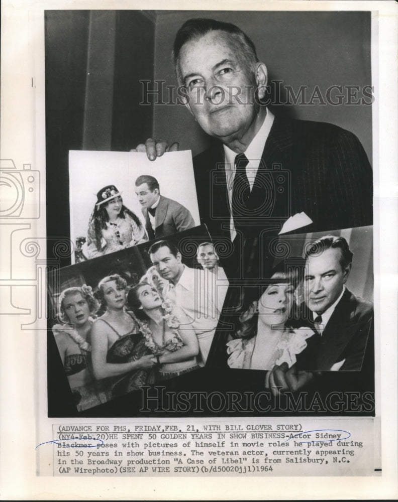 1964 Actor Sidney Blackmer poses with his movie photographs. - Historic Images