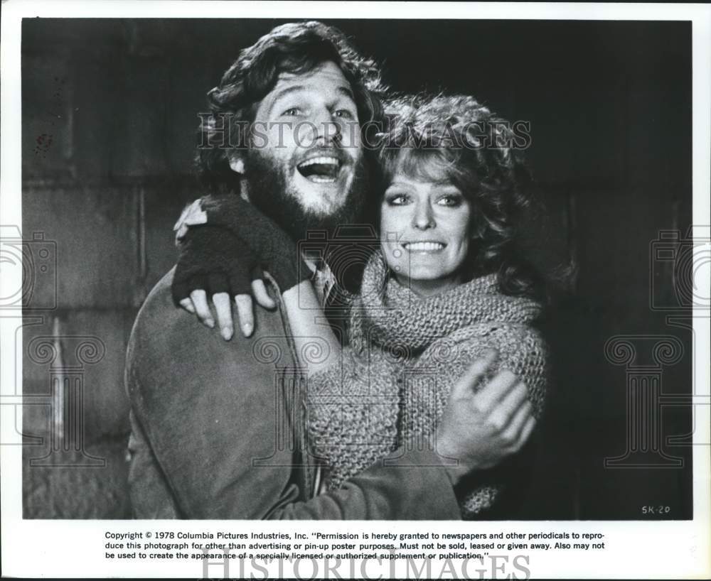1978 Actor Jeff Bridges hugs Farrah Fawcett in a movie scene-Historic Images