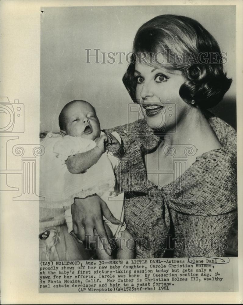 1961 Arlene Dahl holds up her daughter Carole Christian Holmes - Historic Images