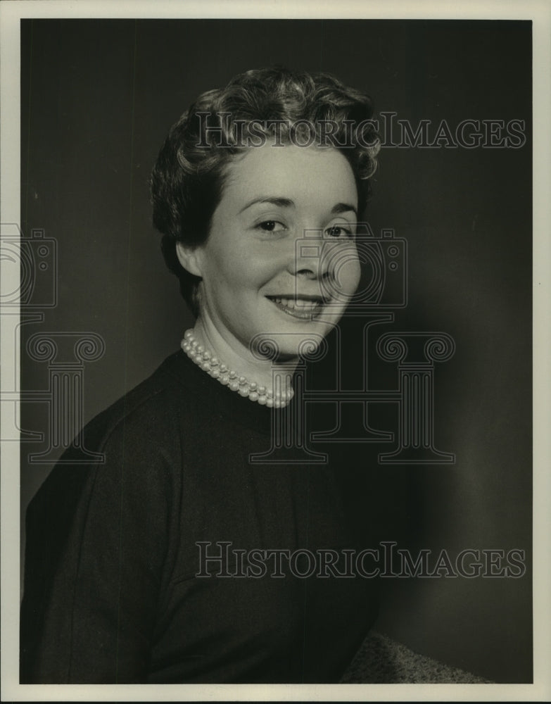 1955 Press Photo Adina Coe, in a dark dress and pearls - nop17064-Historic Images