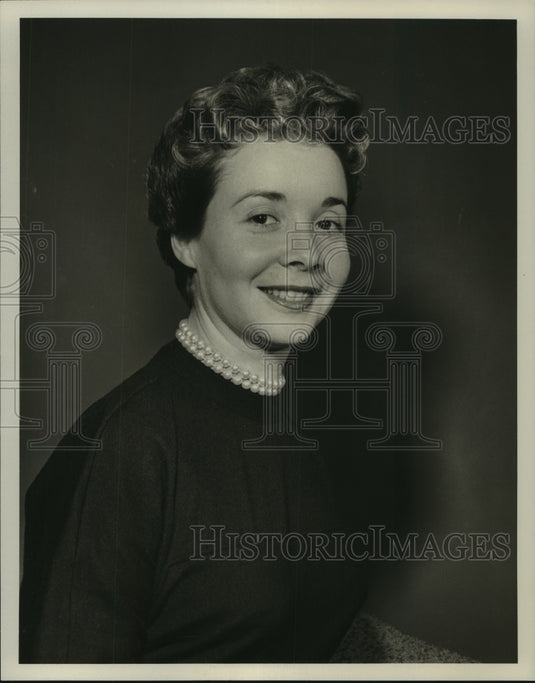 1955 Press Photo Adina Coe, in a dark dress and pearls - nop17064-Historic Images