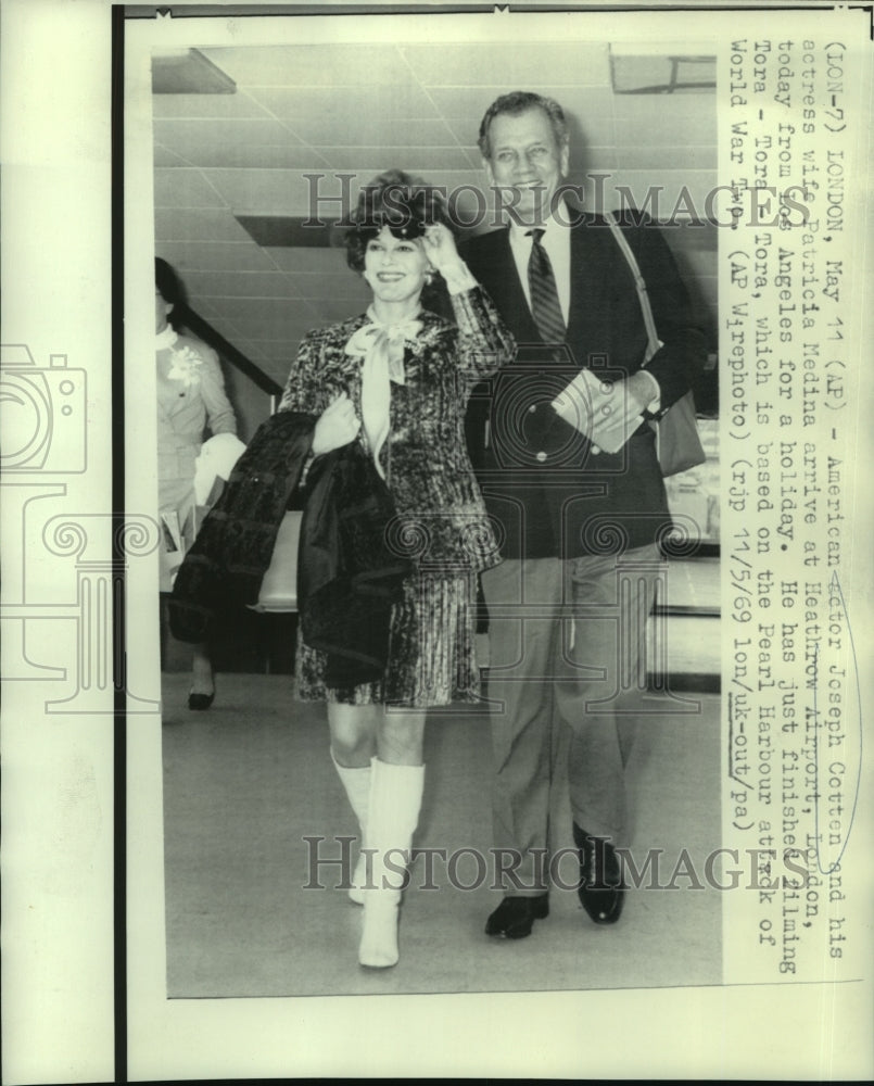 1969 Joseph Cotten and wife, Patricia Medina, arrive in London. - Historic Images