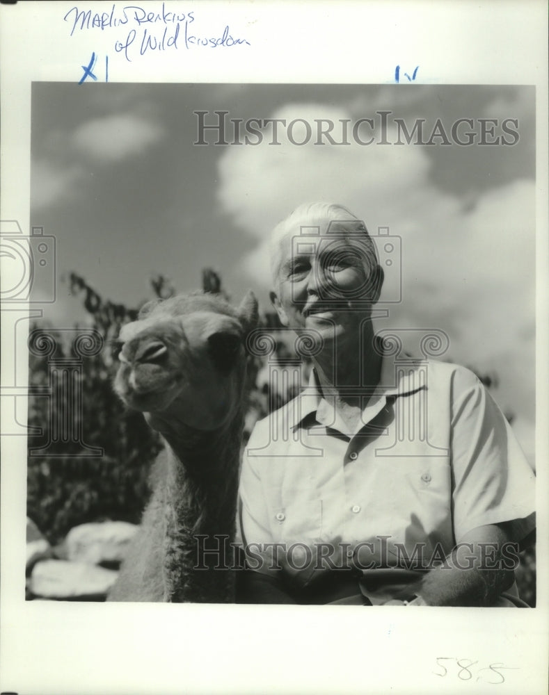 1980 Animal expert Dr. Marlin Perkins appearing here with a camel. - Historic Images