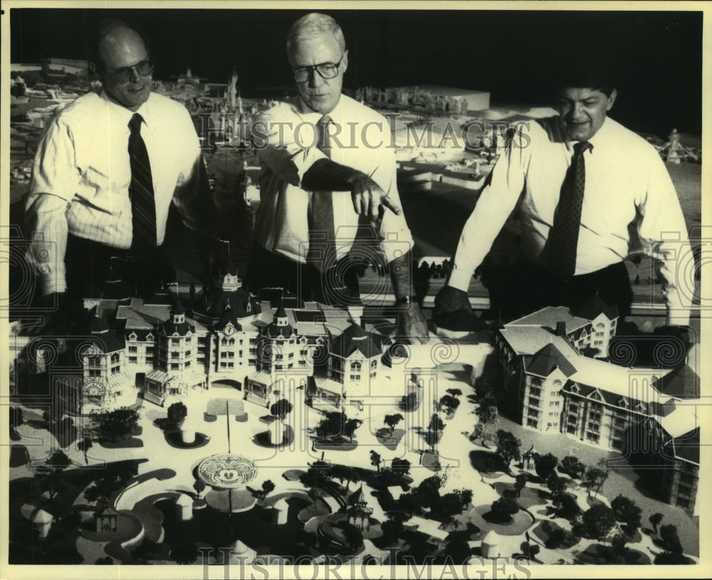 1991 Men Standing Over Plans of EuroDisney - Historic Images