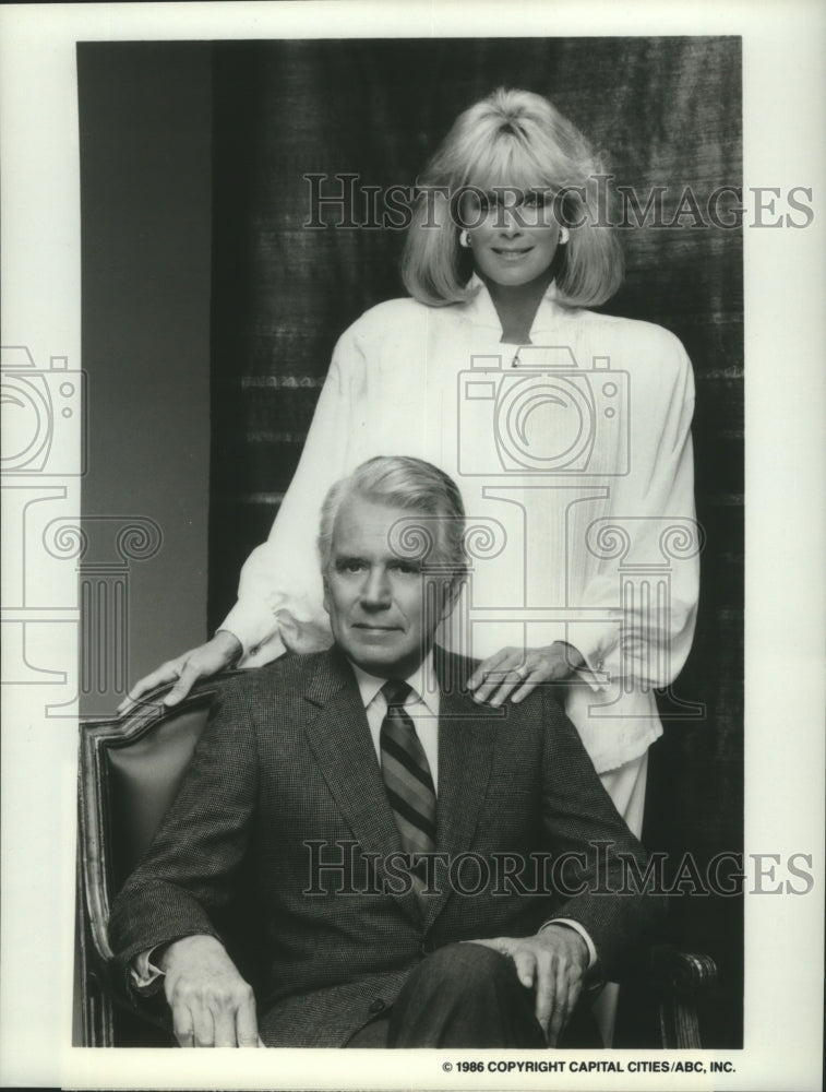 1986 Linda Evans stands behind John Forsythe, &quot;Dynasty&quot; - Historic Images