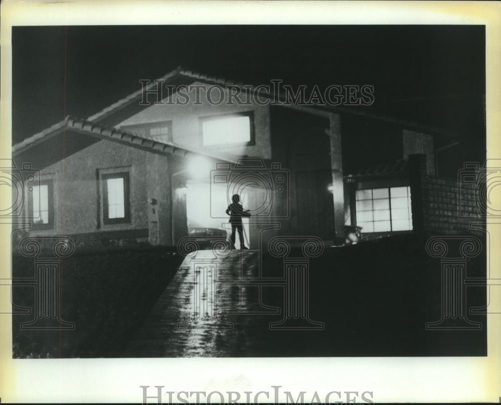 Movie scene with boy in front of house at night - Historic Images