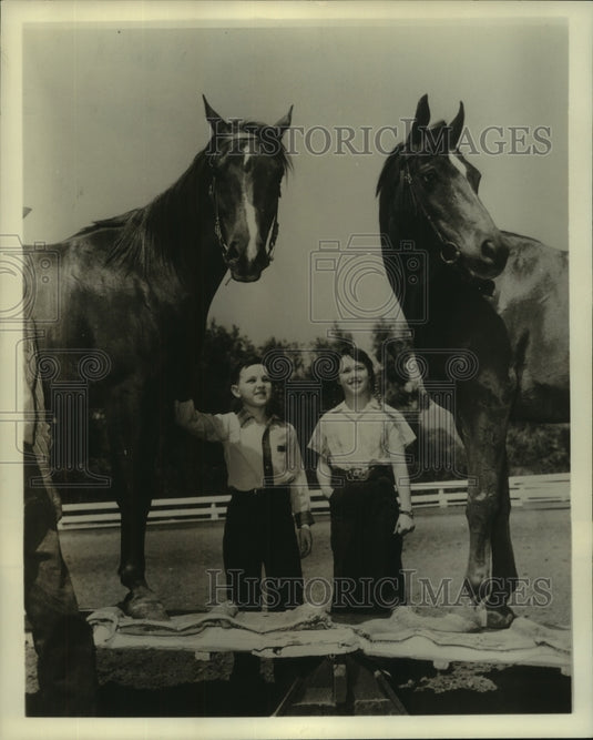 Bald Mighty-Moppets with thoroughbred horses - Historic Images