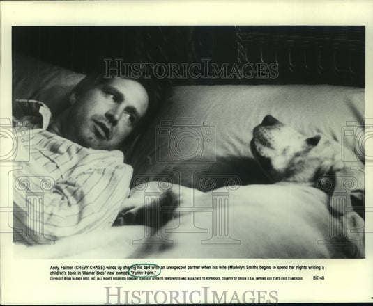 1991 Chevy Chase with a dog in Warner Bros.' comedy "Funny Farm" - Historic Images