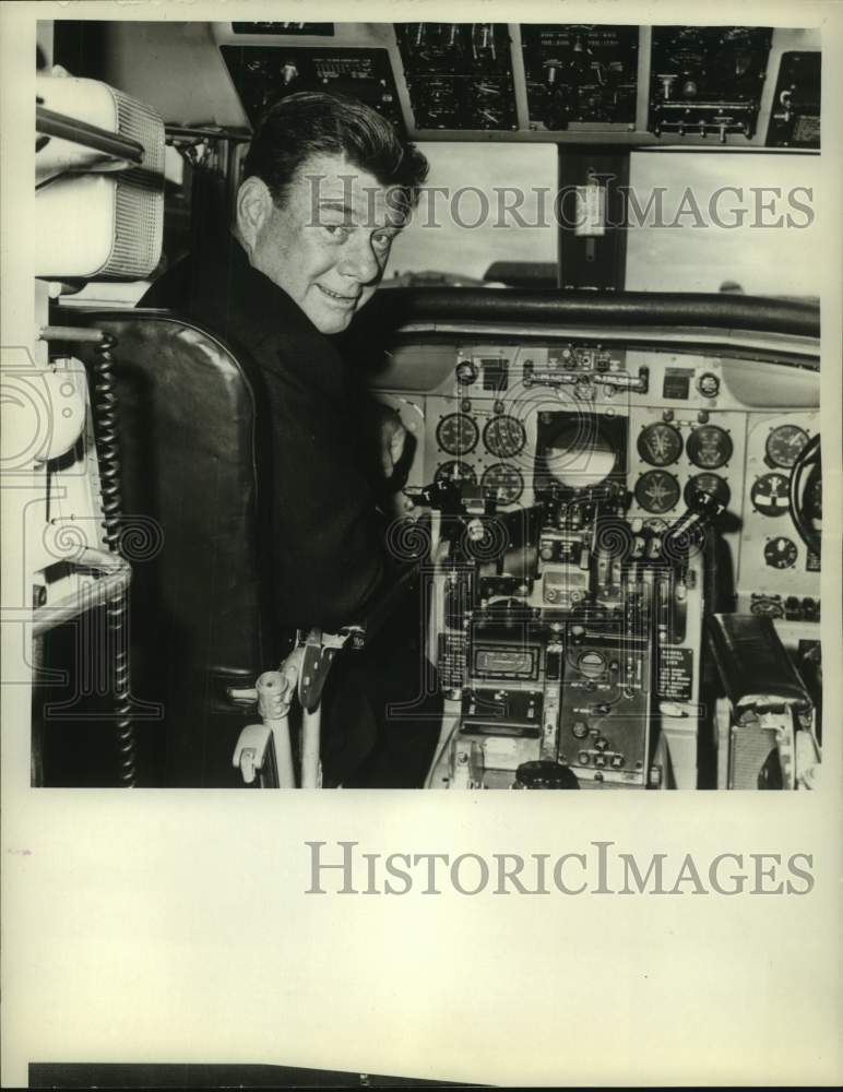 1964 Press Photo Radio host Arthur Godfrey at the controls of a jet plane. - Historic Images