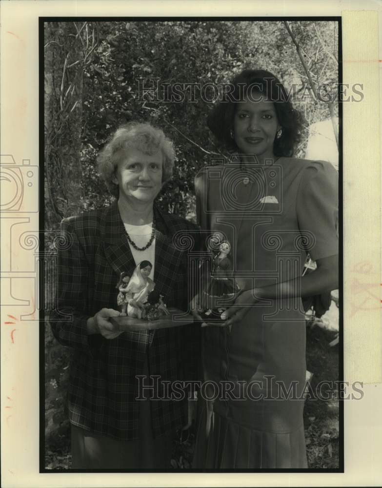 1991 Sylvia Warren and Sally Ann Roberts hold UNICEF awards. - Historic Images