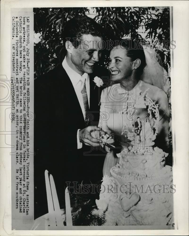 1956 Roger Smith and Victoria Shaw cut cake at Los Angeles reception - Historic Images