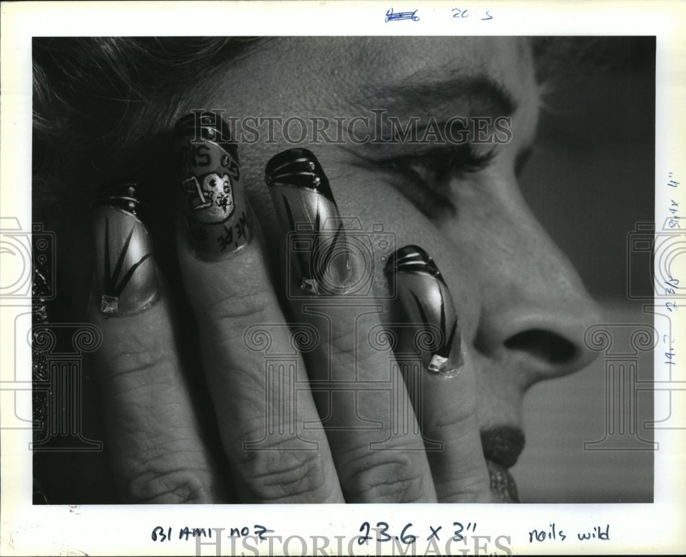 1991 New Orleans Saints- Saints fan Margie Rovira has helmet nails. - Historic Images