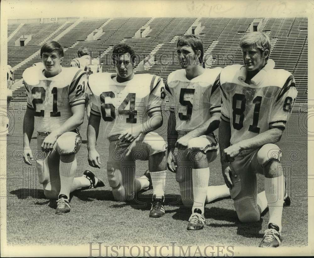 1973 Press Photo Four football players kneel down on field for a photo - Historic Images