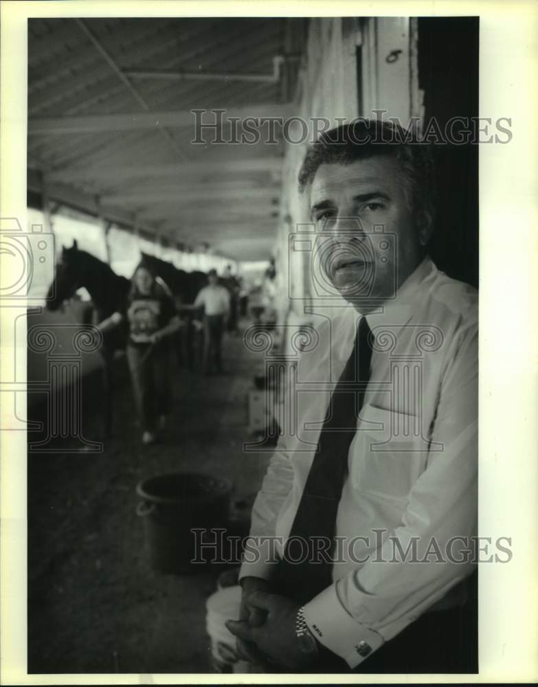 Press Photo Ronny Lamarque stands in race horse barn of Louis Rousell - Historic Images
