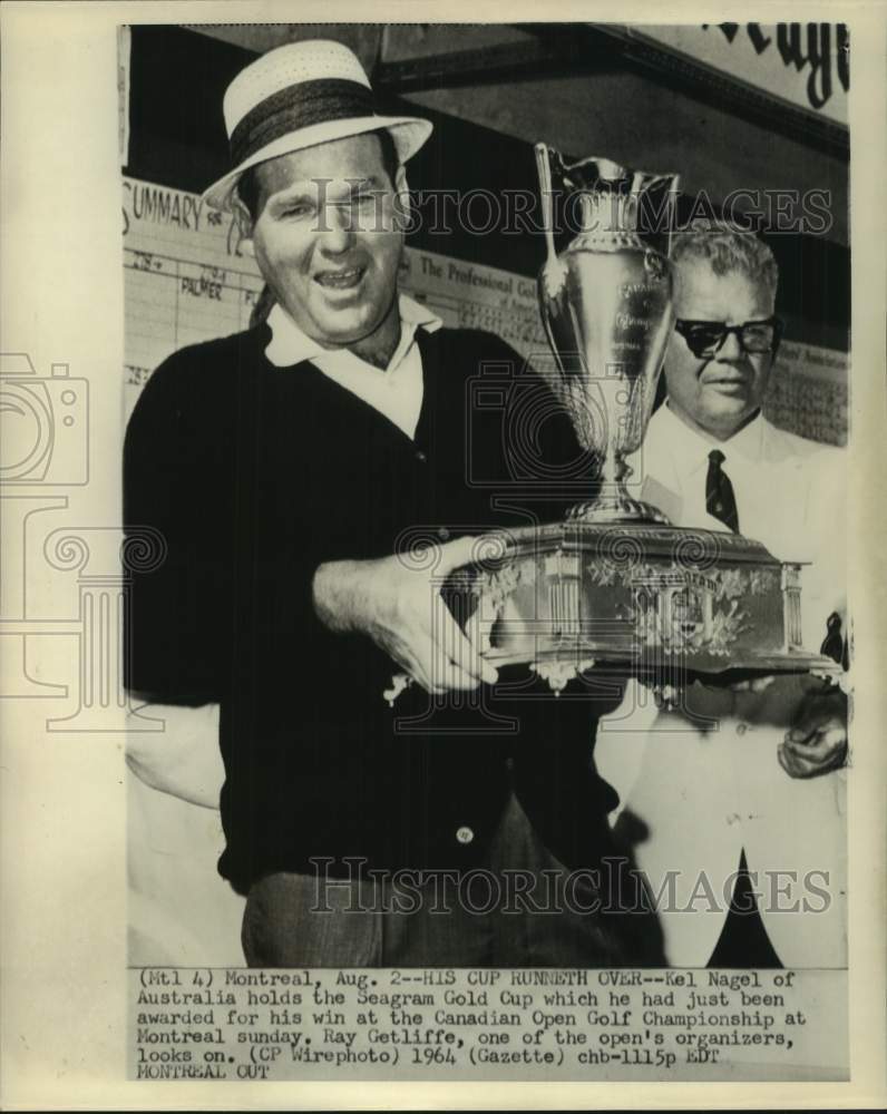 1964 Press Photo Golfer Kel Nagle holds the Seagram Gold Cup in Montreal - Historic Images