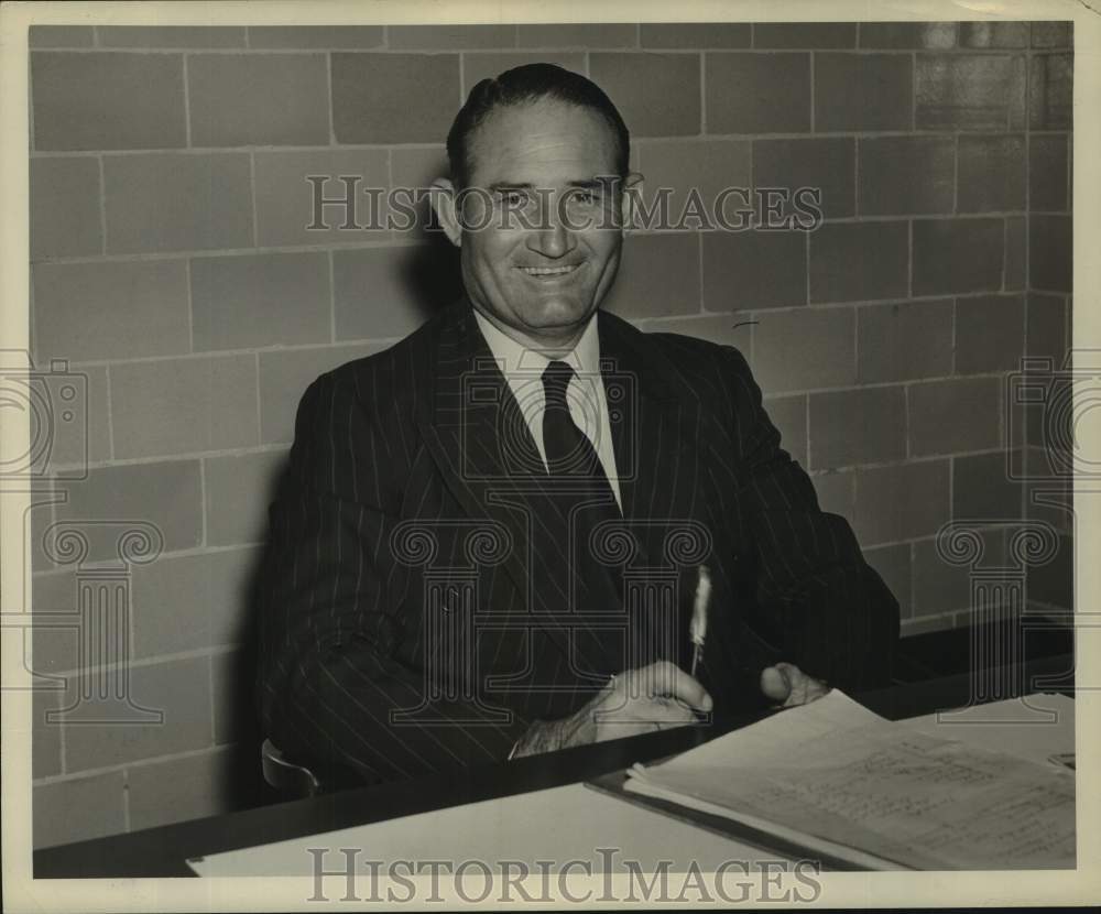 Louisiana State University coach Harry Rabenhorst sits behind desk - Historic Images